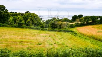 travel to France - harvested field on Launay bay of Atlantic coast in Ploubazlanec commune of Paimpol region in Cotes-d'Armor department of Brittany in summer eveining