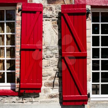 travel to France - window of old house with red wooden shutters in Vitre town in Ille-et-Vilaine department of Brittany in sunny summer day