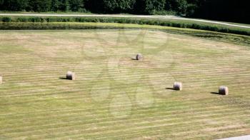 country landscape - above view of groomed lawn with grass bales in Val de Loire region of France in summer day