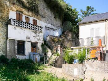travel to France - old urban cave houses in rock on street Rue Victor Hugo in Amboise town in Val de Loire region in sunny summer day