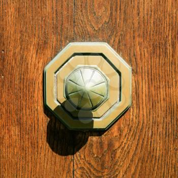 travel to France - old brass door knob at outdoor wooden door in Blois town in Val de Loire region in summer sunny day