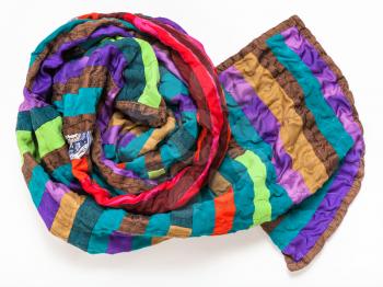 rolled stitched patchwork scarf from silk bands on white background