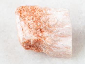 macro shooting of natural mineral rock specimen - raw Selenite stone on white marble background from Vodinskoye mine in Samara Region of Russia