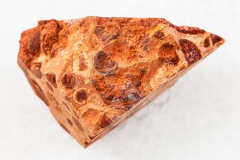 macro shooting of natural mineral rock specimen - raw bauxite ore on white marble background from Ukraine