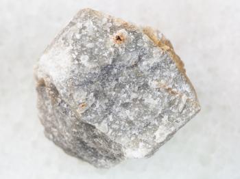 macro shooting of natural mineral rock specimen - piece of raw green marble stone on white marble background from Moscow Region, Russia