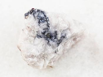 macro shooting of natural mineral rock specimen - raw Wolframite ore on white marble background from North Caucasus