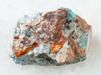 macro shooting of natural mineral rock specimen - rough Scorodite stone on white marble background from Jezkazgan region, Kazakhstan