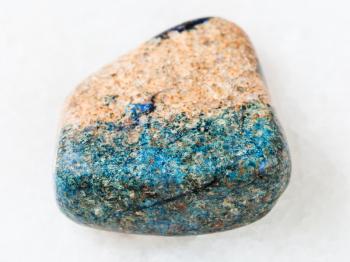 macro shooting of natural mineral rock specimen - pebble of azurite stone on white marble background from Kazakhstan