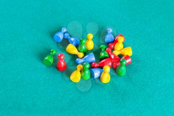 above view of many wooden board game pawns on green baize table