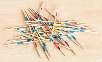 pile from wooden sticks of Mikado pick-up sticks game on wood board