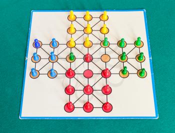 gameplay of solitaire board game on green baize table. The first mention of the game can be identified in France in 1697