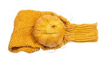 top view of skein of yellow yarn on knitted sweater sleeve isolated on white background