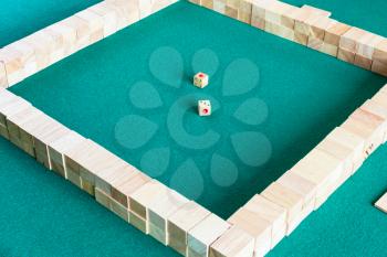 starting position of mahjong, tile-based chinese strategy board game on green baize table