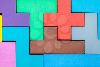 assembled puzzle from colored wooden pentominoes and blocks