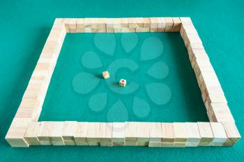starting walls of mahjong, tile-based chinese strategy board game on green baize table