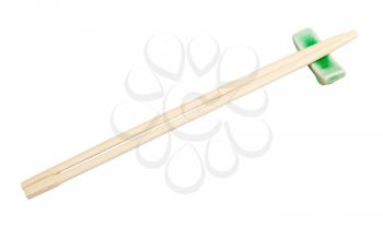 disposable wooden chopsticks served on chopstick rest isolated on white background