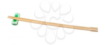 side view of beech wooden chopsticks served on chopstick rest isolated on white background