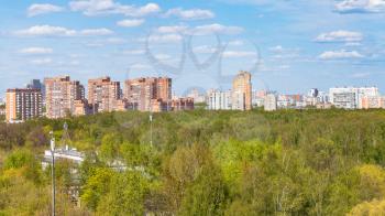 panoramic view of city park and residential district in sunny spring day