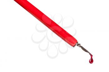 side view of ink drop dripping from tip of nib of red dip pen close up isolated on white background