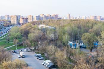 aerial view of car parking , street and city park in residential district of Moscow city in spring evening twilight