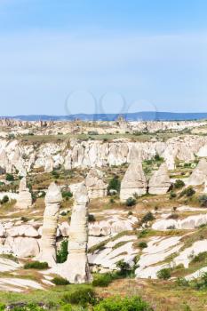 Travel to Turkey - landscape with fairy chimney rocks in mountains of Goreme National Park in Cappadocia in sunny spring day