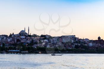 Travel to Turkey - view of Fatih district in Istanbul city in spring evening from Golden Horn bay