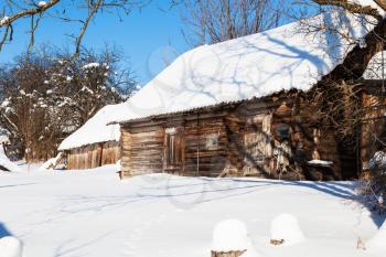 abandoned wooden russian rural house in sunny winter day in little village in Smolensk region of Russia