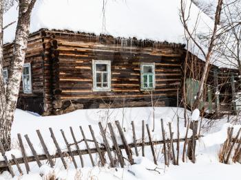 old russian wooden rural house in winter in little village in Smolensk region of Russia