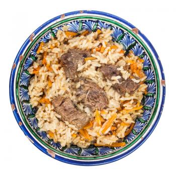 top view of prepared plov (central asian dish from rice with meat and vegetable) in traditional ceramic bowl isolated on white background