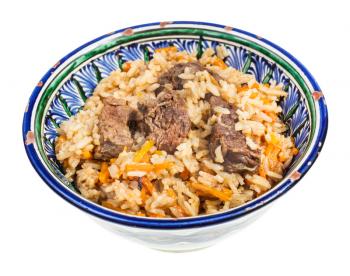 above view of prepared plov (central asian dish from rice with meat and vegetable) in traditional ceramic bowl isolated on white background