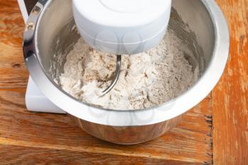 cooking of pie - kitchen processor kneads dough
