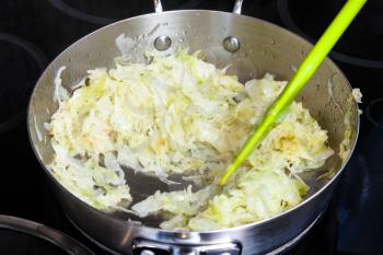 cooking of pie - braising cabbage for stuffing in frying pan