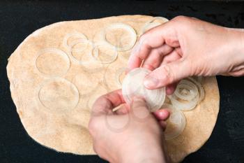 cooking of pie - spreading of onion rings on sheet of dough