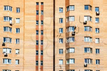 front view of urban brick apartment house in Moscow city on sunny summer day