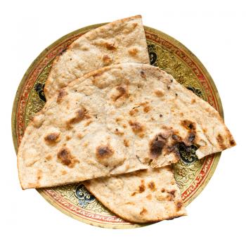 Indian cuisine - Tandoori Roti whole wheat flat bread on brass plate isolated on white background