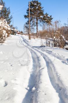 ski track at outskirt of russian village in sunny winter day in Smolensk region of Russia