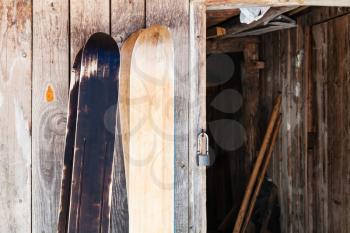 two pairs of wide forest skis near wooden shed in winter in russian village in Smolensk region of Russia