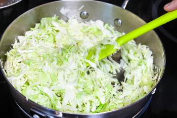 cooking of pie - stewing fresh cabbage for stuffing in frying pan