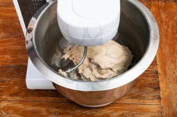cooking of pie - kitchen processor kneads ball of dough