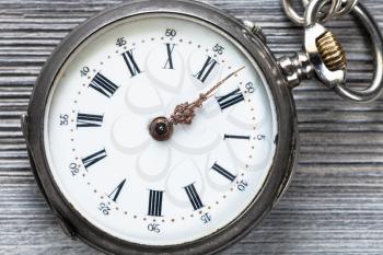 retro pocket watch on wooden background close up