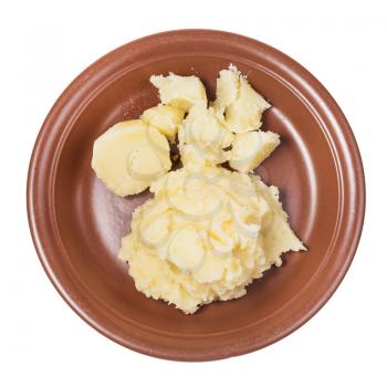top view of boiled and mashed potatoes on brown plate isolated on white background