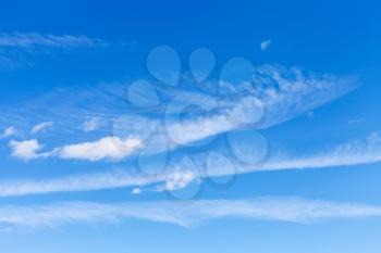light spindrift and cumulus clouds in blue sky in sunny september day