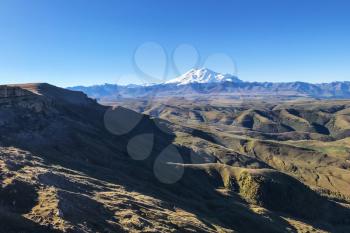 travel to North Caucasus region region - view of Mount Elbrus and Bermamyt Plateau at morning