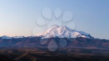 travel to North Caucasus region region - panoramic view of Mount Elbrus from Bermamyt mountain Plateau at september dawn