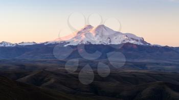 travel to North Caucasus region region - panoramic view of Mount Elbrus from Bermamyt mountain Plateau at sunrise