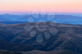 travel to North Caucasus region region - view of Caucasus Mountains from Bermamyt mountain Plateau at blue dawn