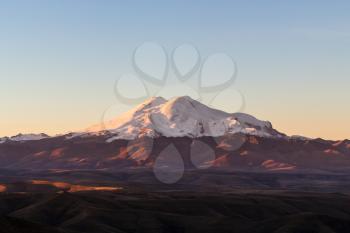 travel to North Caucasus region region - view of Mount Elbrus from Bermamyt Plateau during rising of the sun