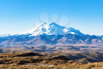 travel to North Caucasus region region - view of Mount Elbrus from Bermamyt Plateau at september morning
