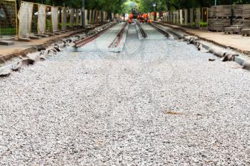 repair of tram tracks in Moscow city - laying of new rails on the tram track on crushed stone