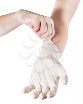 female hand wears latex glove on another hand isolated on white background